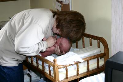 Mommy lotioning up the baby parts