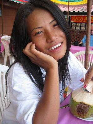 Thai girl enjoying coconut