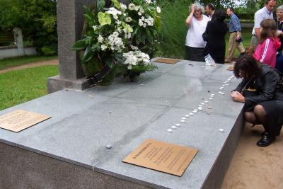 The refurbished memorial;  Ann Rabinowitz and members of the group