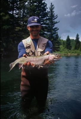rookie flyfisherman with dry-flied rainbow