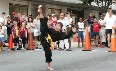 A young blackbelt shows her high kick.
Barbeque Festival Lexington.