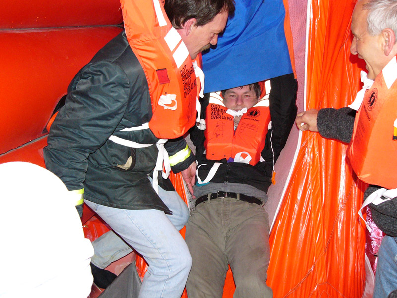 Crew during training exiting the chute bottom.