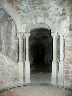 cave entrance at the base of the initiative well
