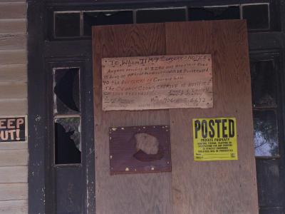 sign on door of haunted house left
