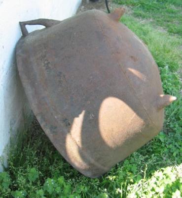 one of several large cast iron kettle that I have leaning up against the outside building (not for sale, sorry)
