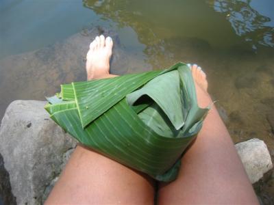 bungkus lunch in a banana leaf (step one, open), at a local river