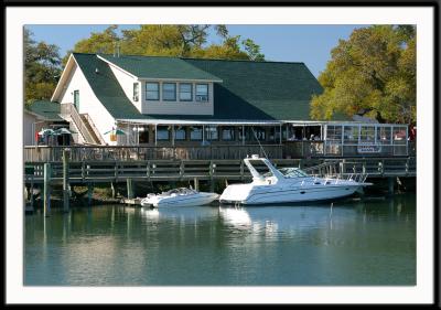 Murells Inlet, south of Myrtle Beach, South Carolina. Famous for its marsh walk and seafood restaurants, it's a great place to walk around in the late afternoon. Seen here is the Dead Dog Saloon, one of the favorite watering holes in Murrells Inlet.
