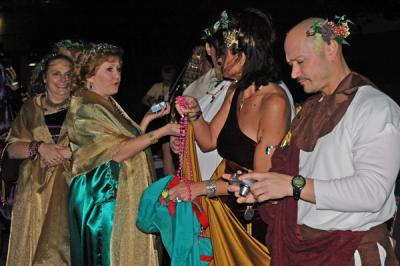 The Toga Krewe attends the Bacchus Parade