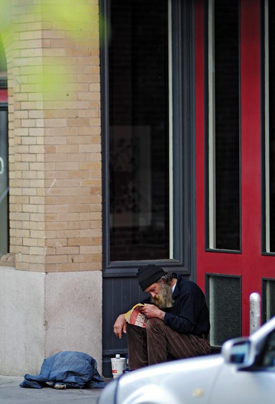 man reading in doorway of Aurobora Press
