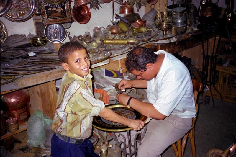 Boy helping in a metalworking shop at the Khan al-Khalili during our 1999 visit