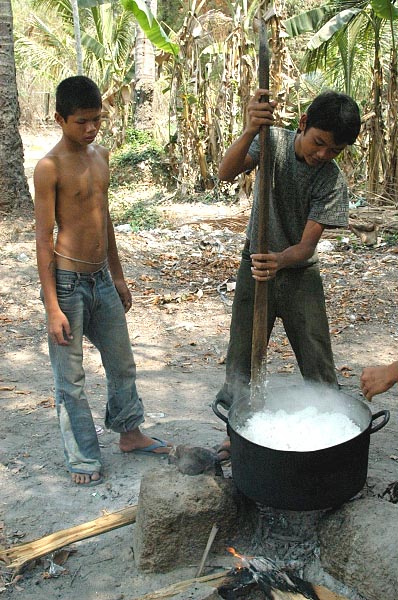 Boys stirring the rice for the meal around 11 am