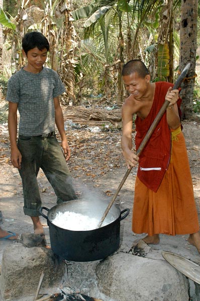 One of the monks shows him how to do it better