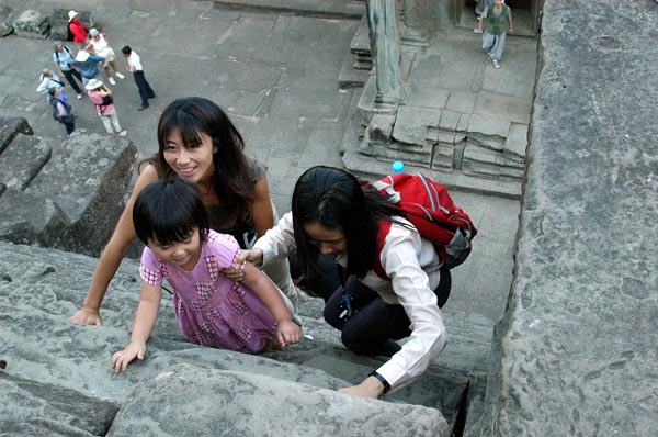 Tourists climbing the steep stairs