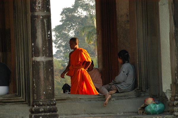 Monk passing through a corridor at Angkor Wat