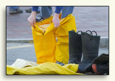 Getting ready for the fish relay race, someone tries on boots and cover-alls...