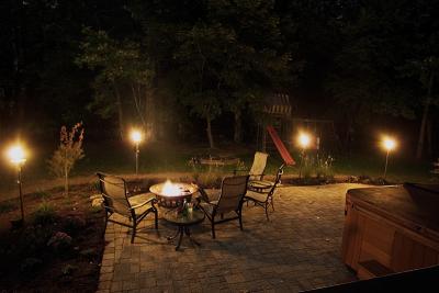 Nighttime by the fire pit and tikis.
