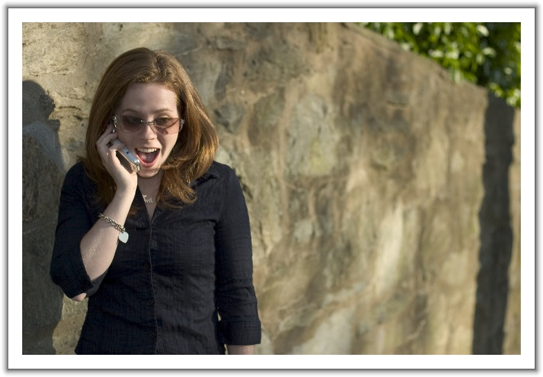 woman on cell receiving amazing news