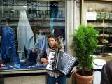 Boy playing music while his dog holds the collection container