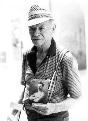 Old man and his pic when he was a young boxer