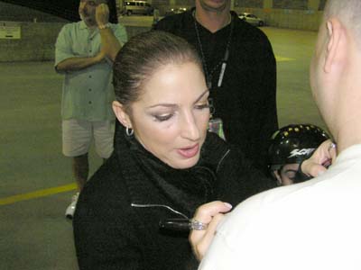 Gloria signing shirt