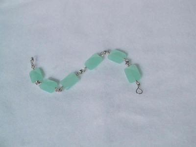 Each chalcedony bead is linked to the next with 3 soldered rings. Sold