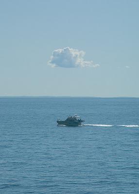 A solitary cloud, a solitary boat