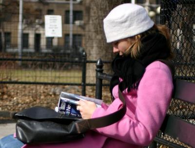 Reading Time Out New York in Washington Square Park