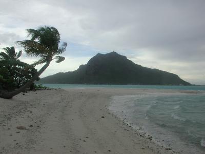 looking west, at the main volcanic island of Maupiti in gale-force winds