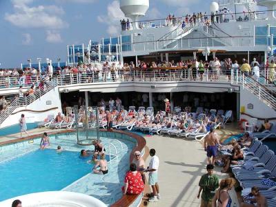 Even before sailing the fun has begun by Neptune's Pool, one of five fresh water pools on board.
