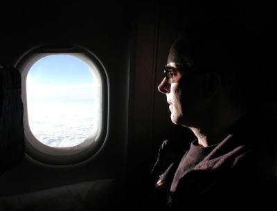 Phil looking out the plane window for the first signs of the Yucatan