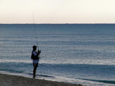 Early morning beach fisherman