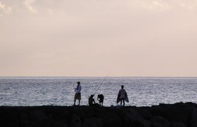 Fishing on the breakwater at Pokai Beach