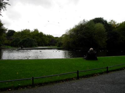 The pond in the Green, and a man relaxing.