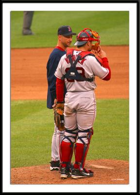 Boston manager Terry Francona and catcher Jason Varitek talk over the situation during a pitching change in Game 1.