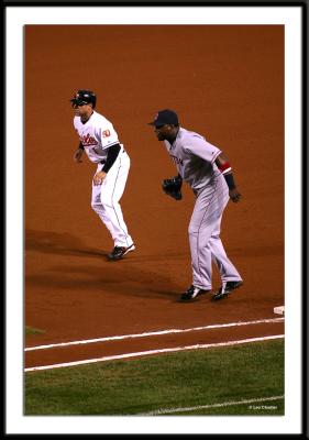 Red Sox first baseman, David Ortiz, holds on the runner during action in the nightcap.
