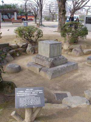 A bomb-blasted tombstone, knocked over