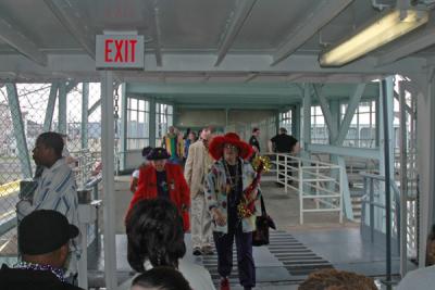 A steady stream of costumed revelers boards the ferry