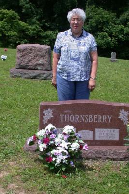 Mary behind her parents' gravestone.