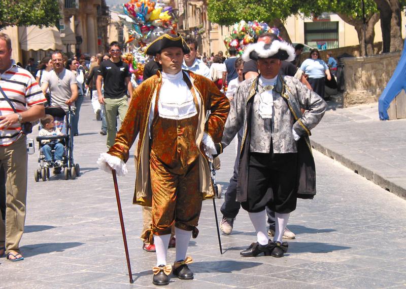 Men in costume announce the festivals evening program