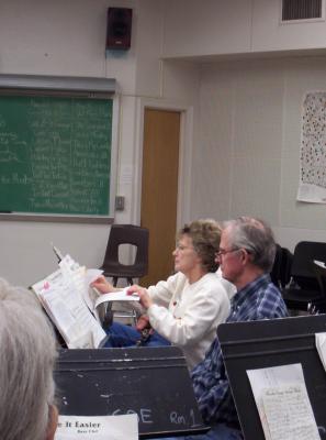 Sharon looking for the next music sheet. She hasn't played Clarinet since high school until 3 years ago when they got involved with this group.
