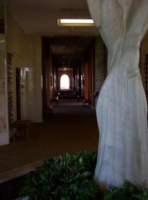 Looking past a sculpture down a long hallway of cripts.