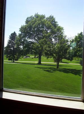 Looking out a window of the mausoleum at part of the cemetary grounds that surround it.