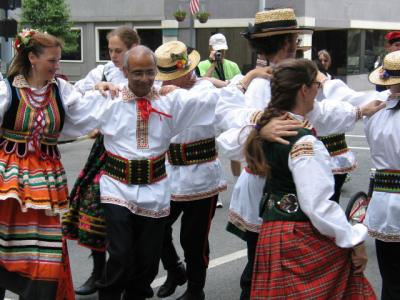 Color parade Poland dancers locked arms