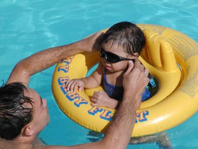 Another water baby enjoys some pooltime with dad.