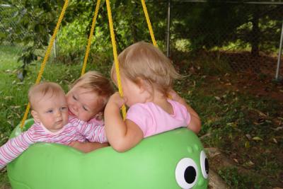 Clara enjoying the swing with the big girls (Rory behind the baby)