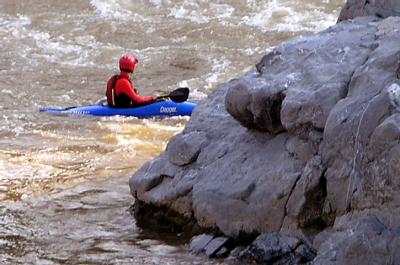 A cayaker paddles upstream