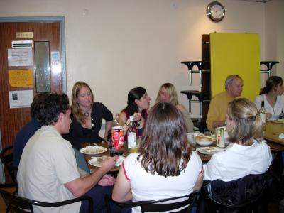 The other end of the table, enjoying the meal and the company.