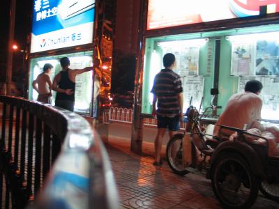 Reading the newspaper at night in Beijing