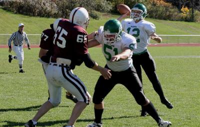 Mike Petrick throwing a pass while David Rossman blocks