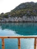 The green of the water near the islands against the color of the boat's wood
